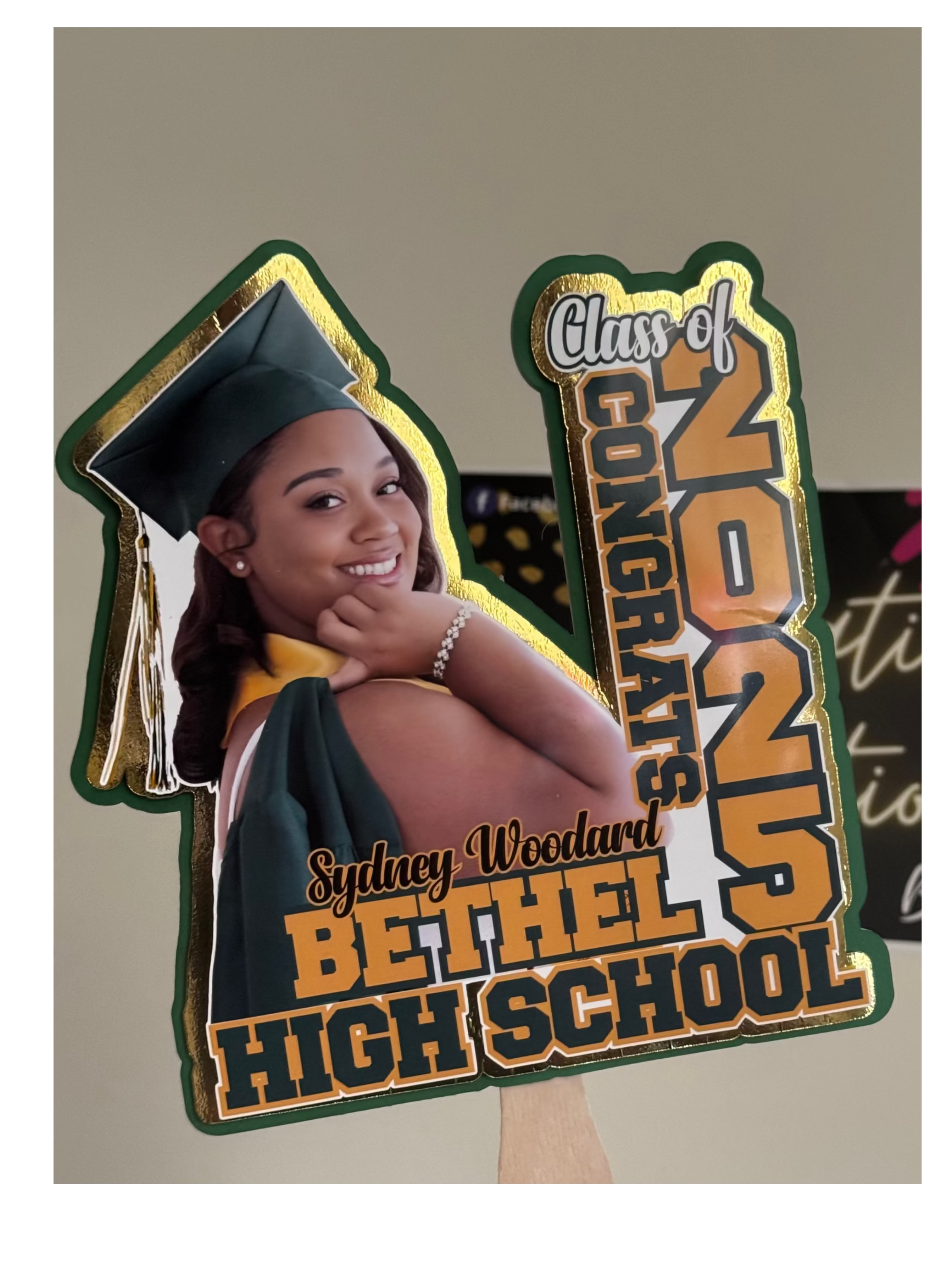 Graduation-themed cutout with a photo of a graduate and text celebrating Bethel High School's Class of 2025.